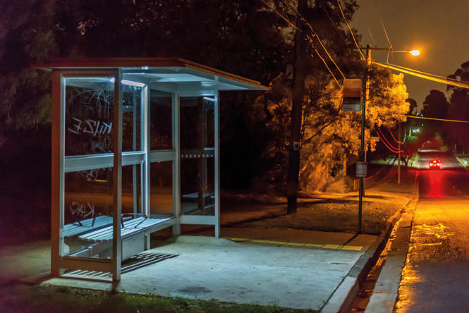 photograph of an empty bus stop late at night